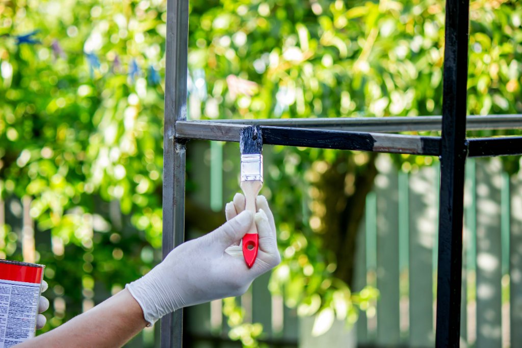 Close-up of exterior painting with a brush
