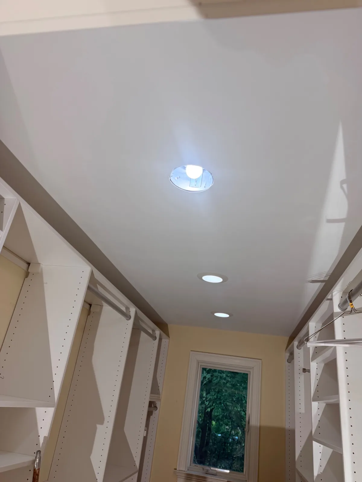 A white closet ceiling in Norwalk after being repaired and repainted following water damage.