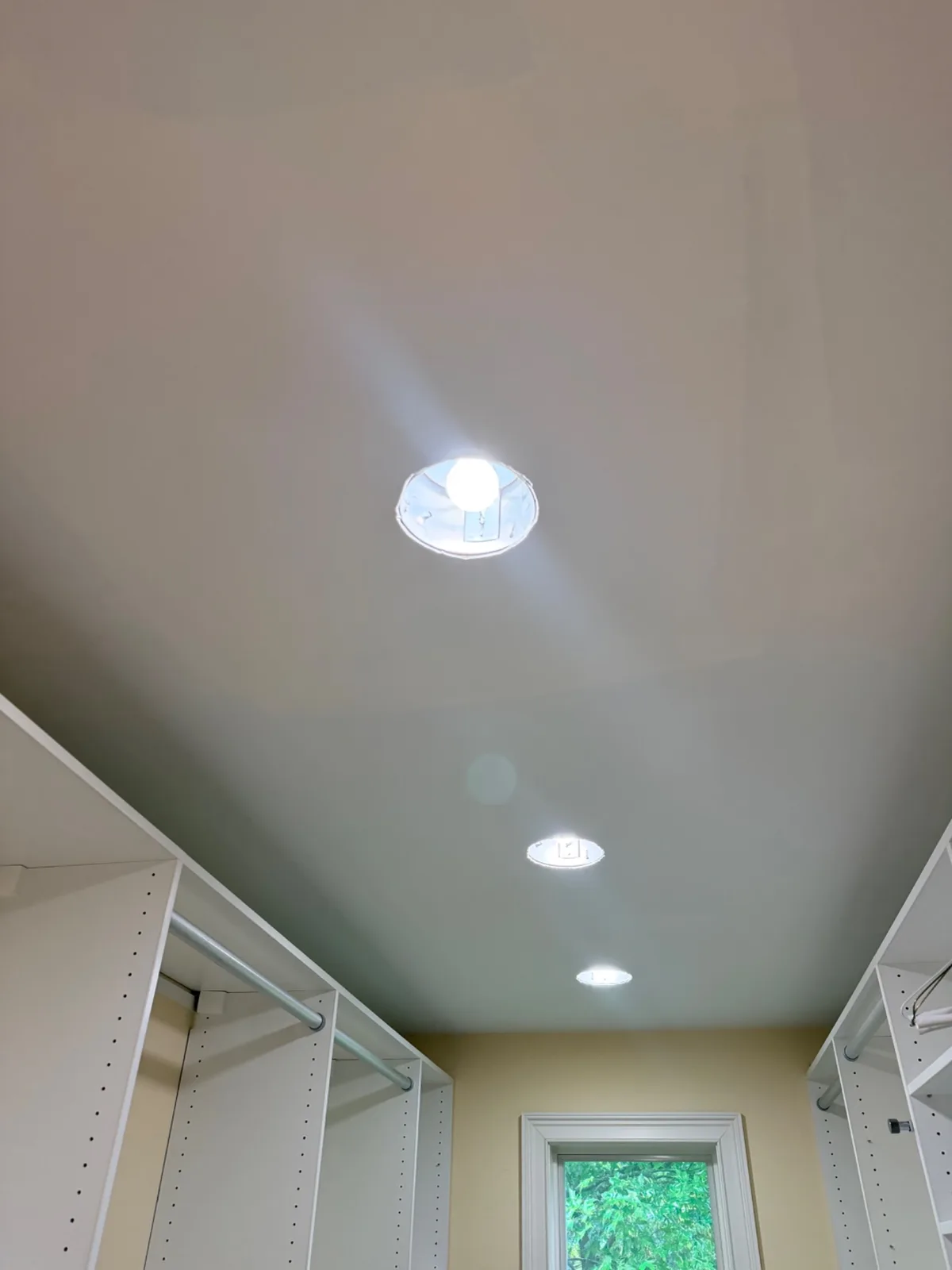 A finished ceiling in a closet with recessed lighting after water damage repairs in Norwalk.