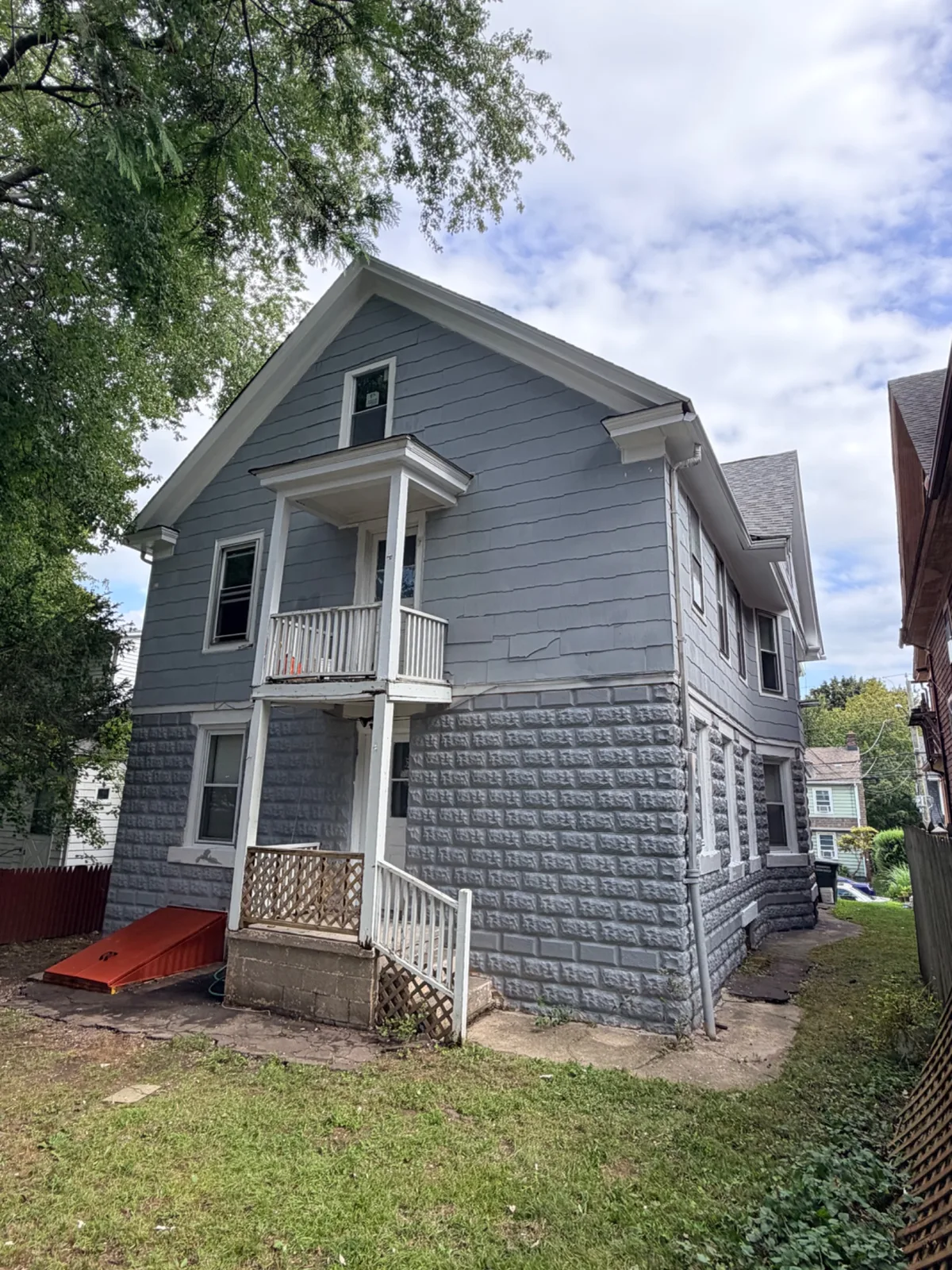 A blue two-story residential house in Bridgeport after exterior painting services were completed.